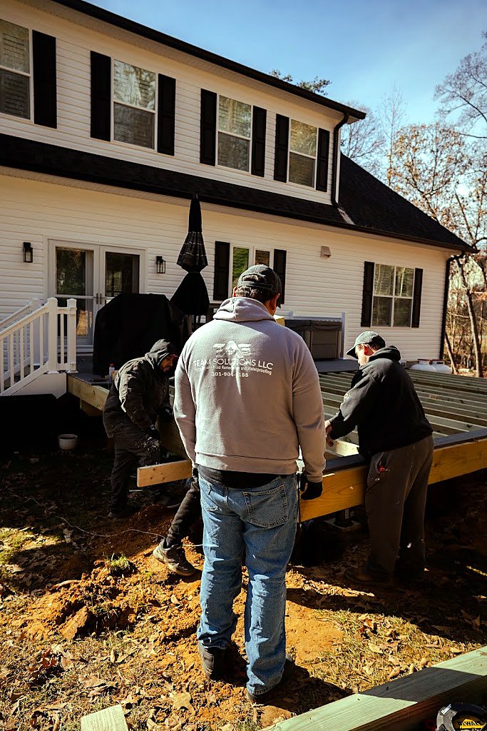 Tag Team Solutions crew framing a deck
